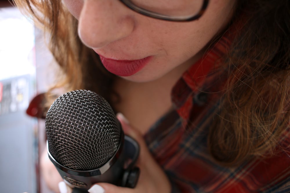 woman listening using white earphones